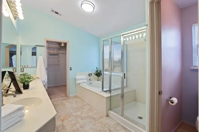 a bathroom with a double vanity sink mirror and toilet