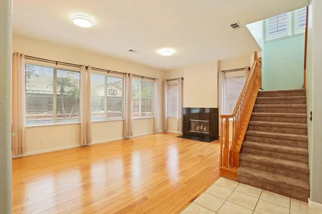 a view of a hallway with wooden floor and staircase