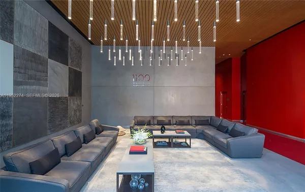 a living room with furniture and a chandelier