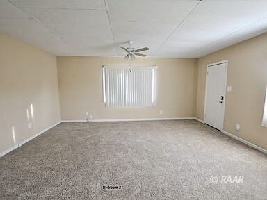 828 North Balsam Street Ridgecrest, CA 93555 - Photo 9 of 32 a view of a livingroom with a ceiling fan & windows