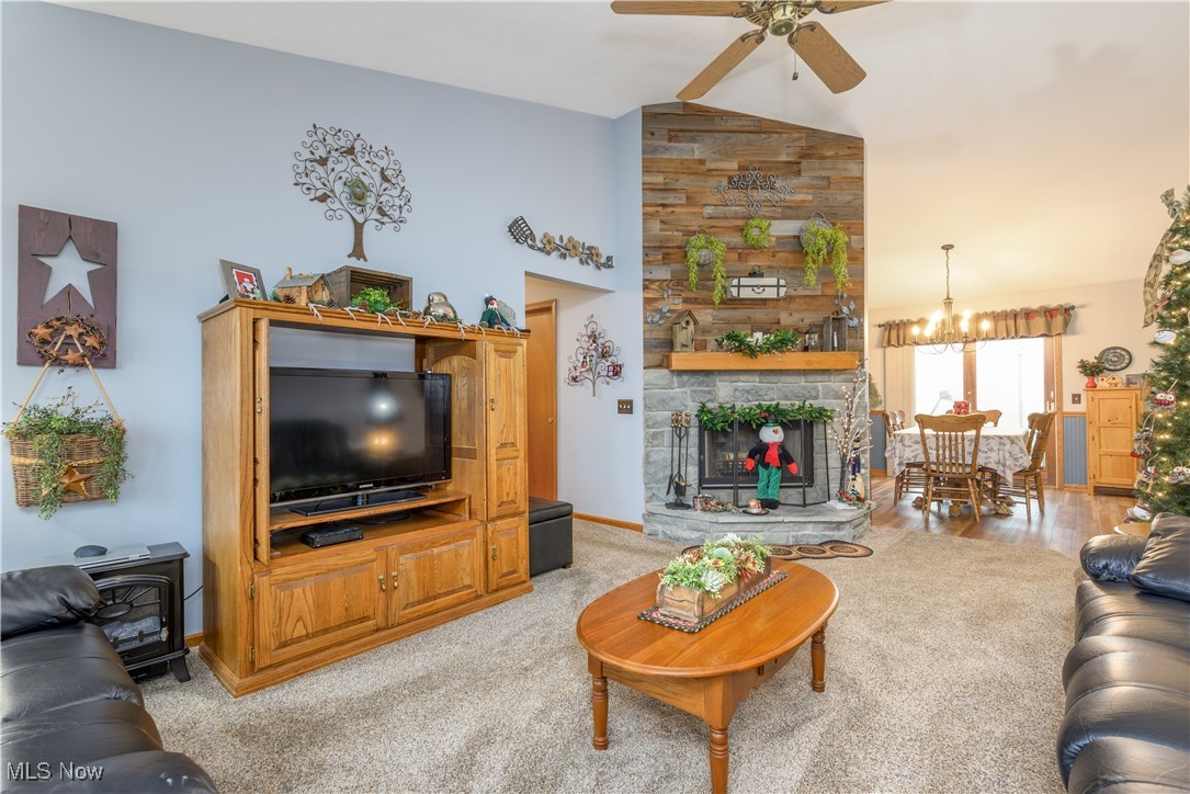 893 Industry Road Atwater, OH 44201 - Photo 10 of 50 Living room with ceiling fan with notable chandelier, light colored carpet, and lofted ceiling