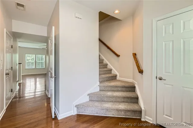 a view of entryway and hall with wooden floor