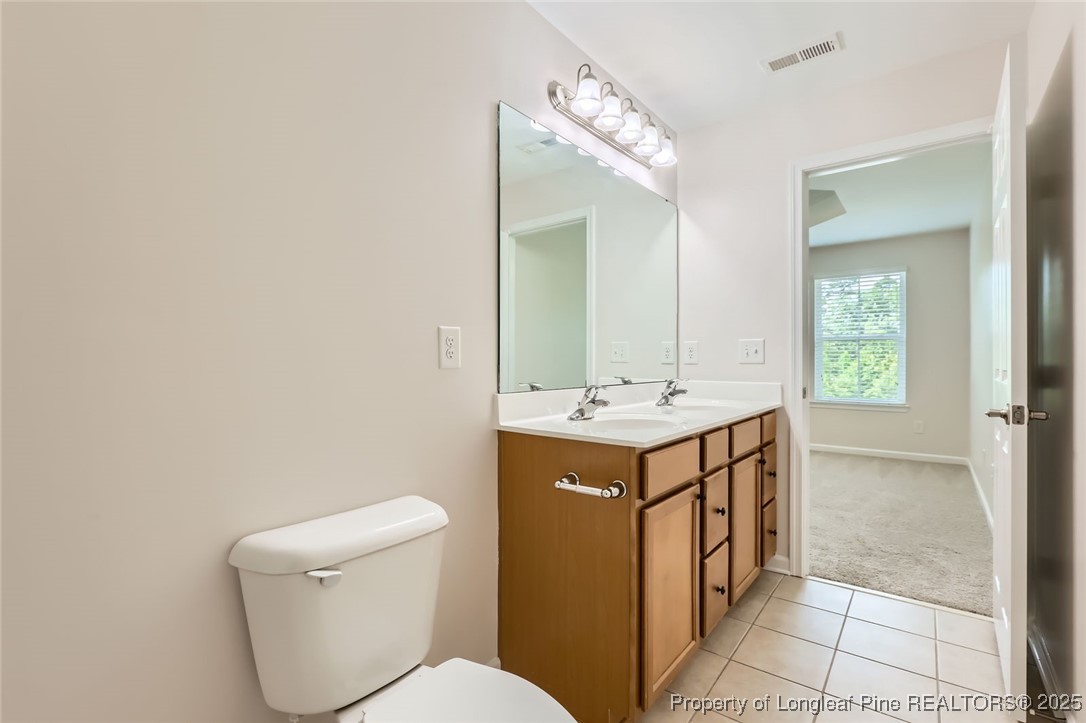408 Panorama View Loop Cary, NC 27519 - Photo 17 of 28 a bathroom with a toilet sink and mirror