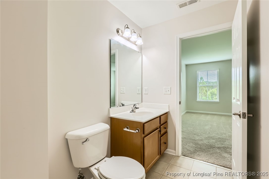 408 Panorama View Loop Cary, NC 27519 - Photo 20 of 28 a bathroom with a toilet sink vanity and mirror