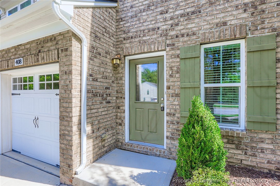 408 Panorama View Loop Cary, NC 27519 - Photo 3 of 28 a view of a brick house with potted plants