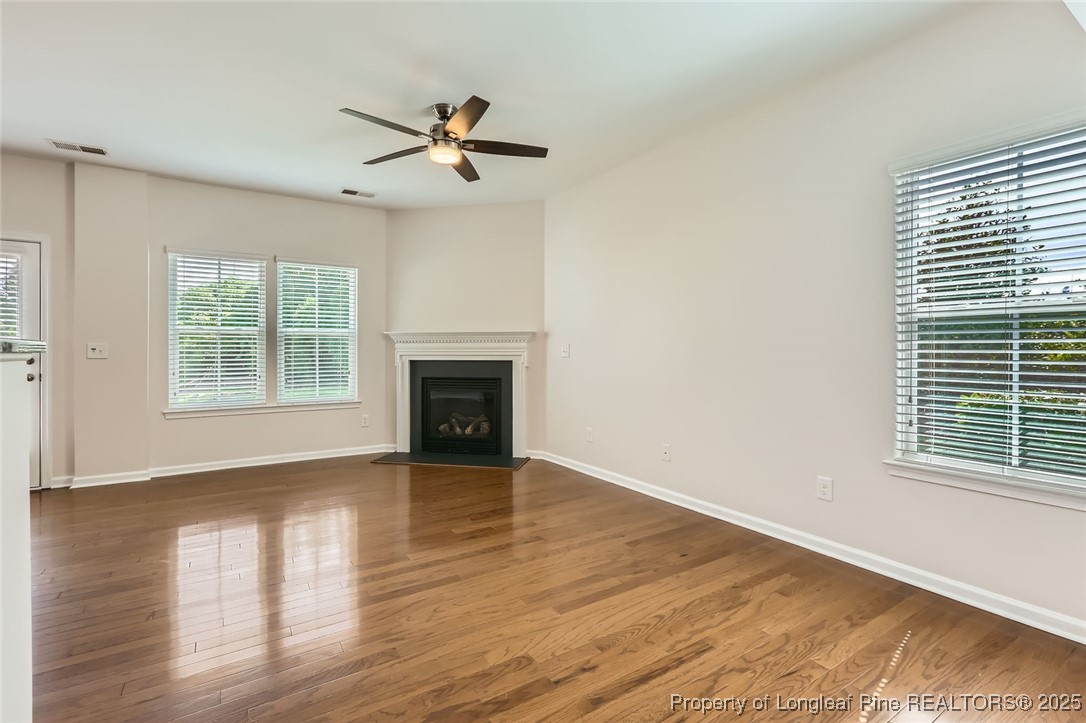 408 Panorama View Loop Cary, NC 27519 - Photo 4 of 28 a view of empty room with wooden floor and fan