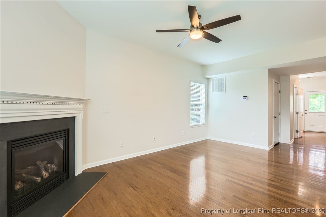 408 Panorama View Loop Cary, NC 27519 - Photo 6 of 28 a view of empty room with wooden floor fireplace and a window