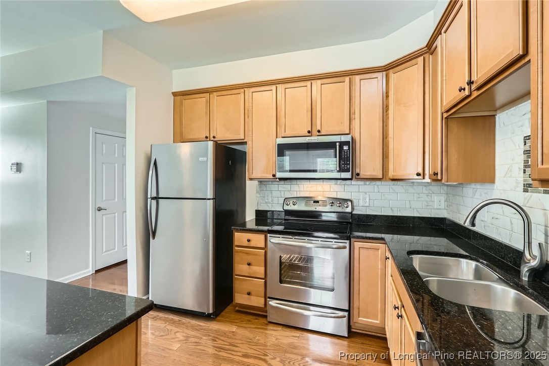 408 Panorama View Loop Cary, NC 27519 - Photo 10 of 28 a kitchen with granite countertop a refrigerator stove and sink