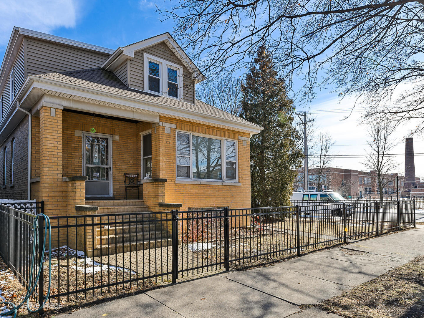 a front view of a house with iron fence