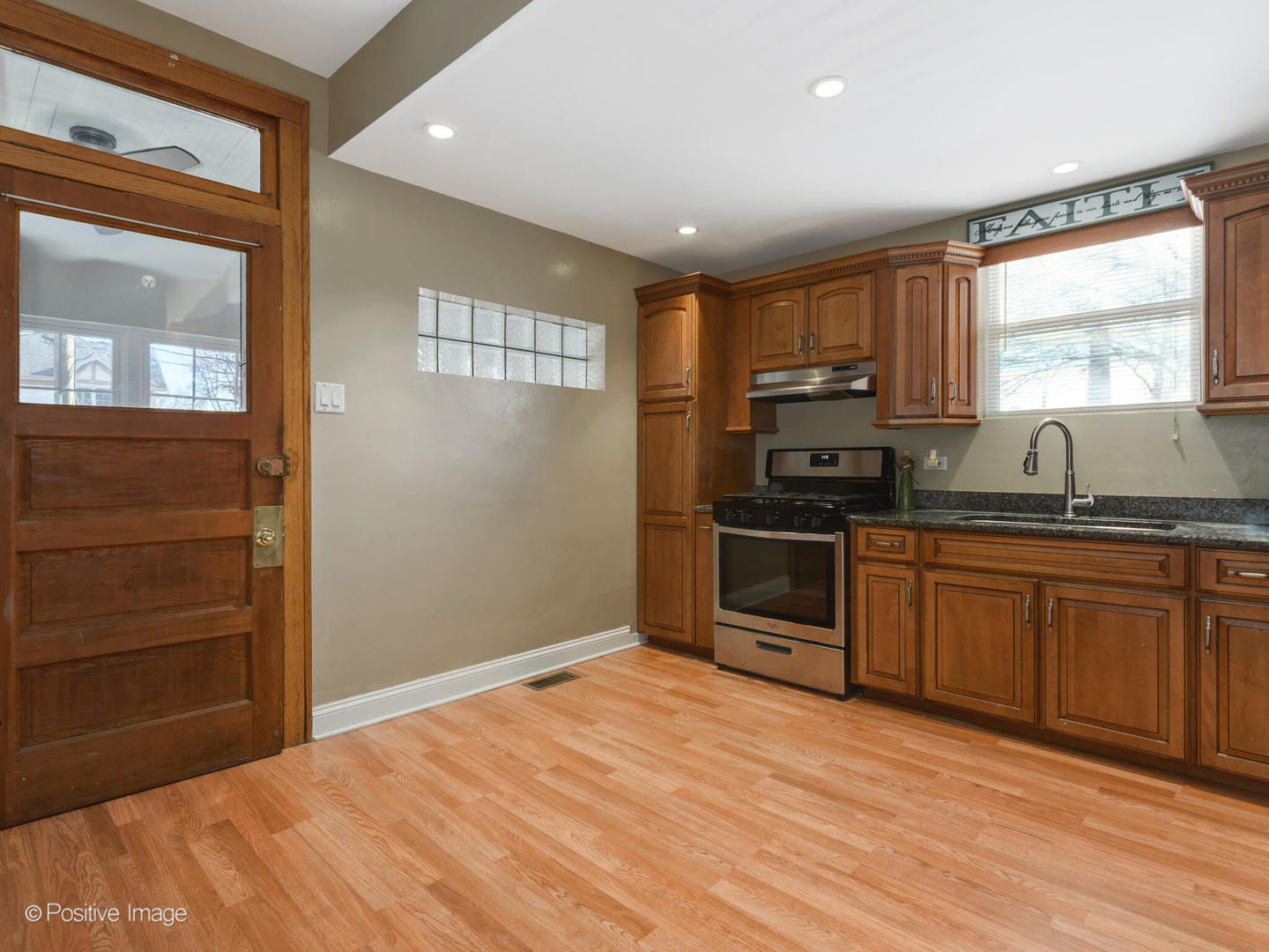 Undisclosed Address Chicago, IL 60630 - Photo 3 of 5 a kitchen with granite countertop a stove a sink and a refrigerator