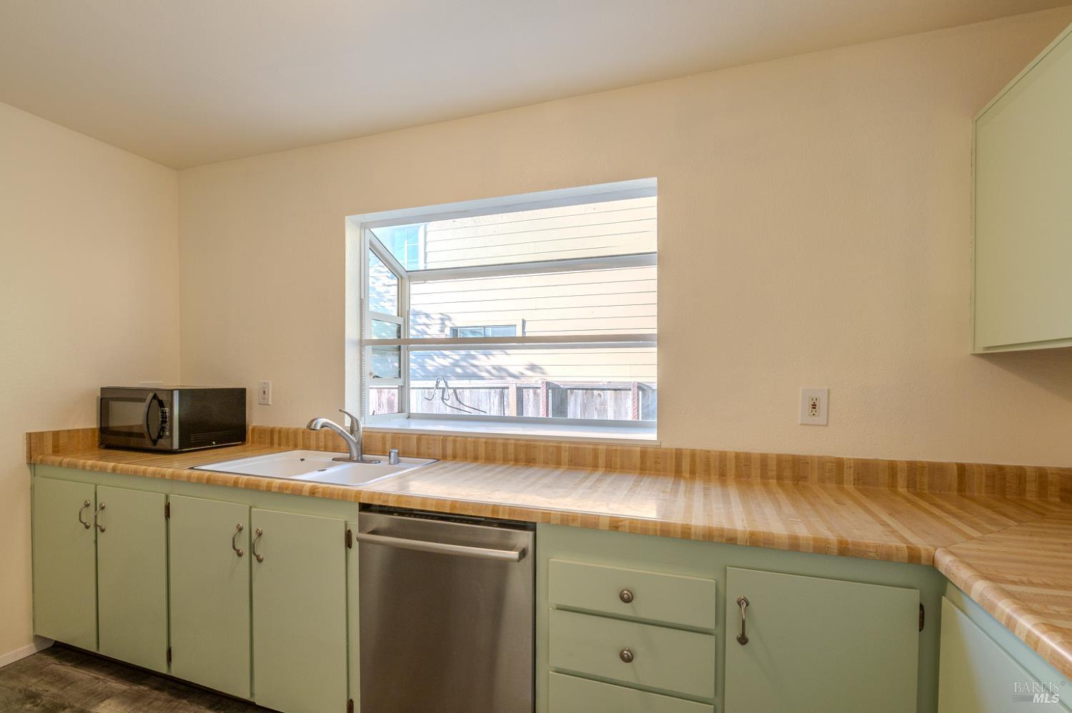 978 Eleanor Avenue Rohnert Park, CA 94928 - Photo 11 of 36 a kitchen with a sink cabinets and window
