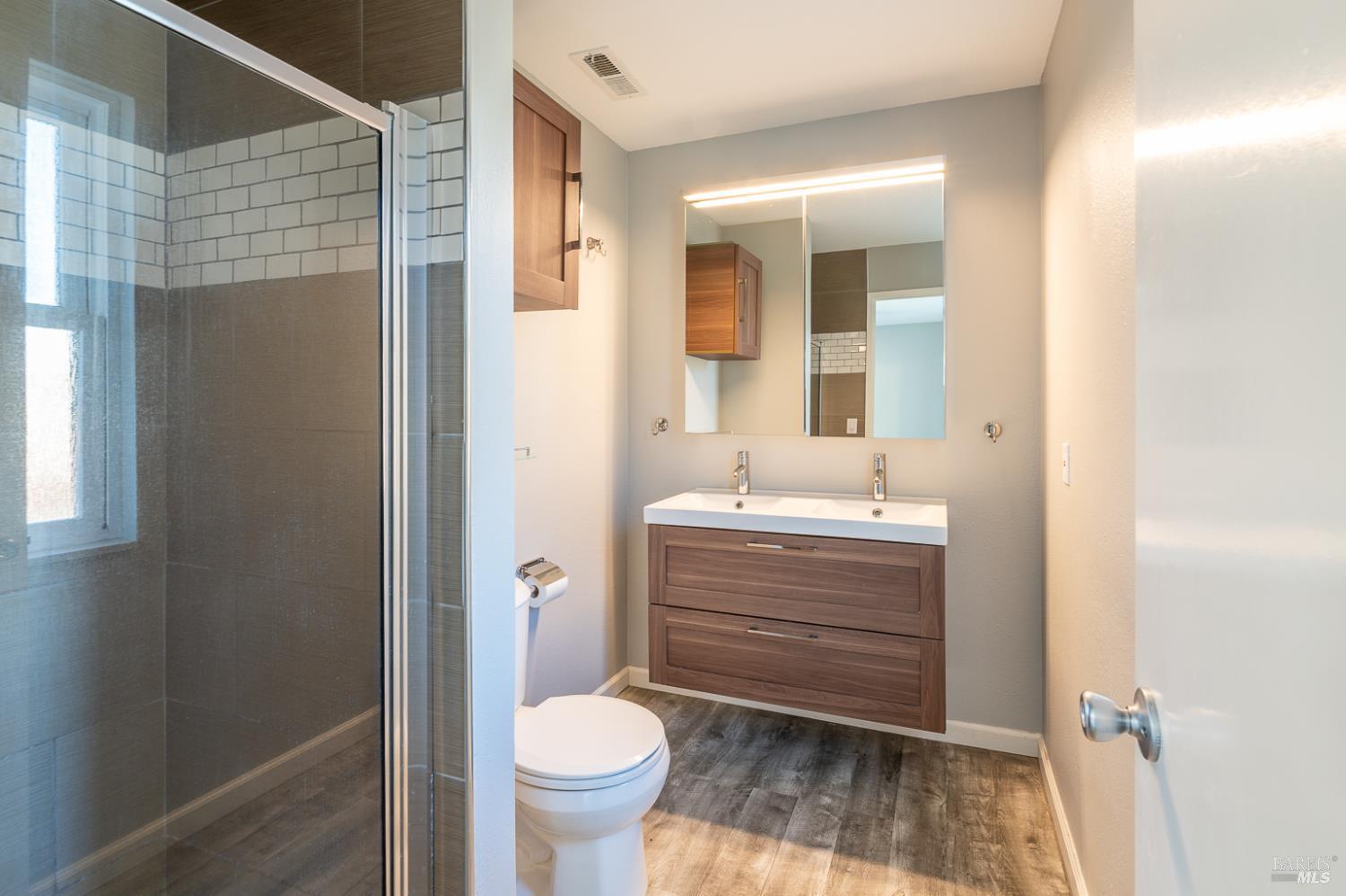 978 Eleanor Avenue Rohnert Park, CA 94928 - Photo 12 of 36 a bathroom with a sink toilet a mirror and shower