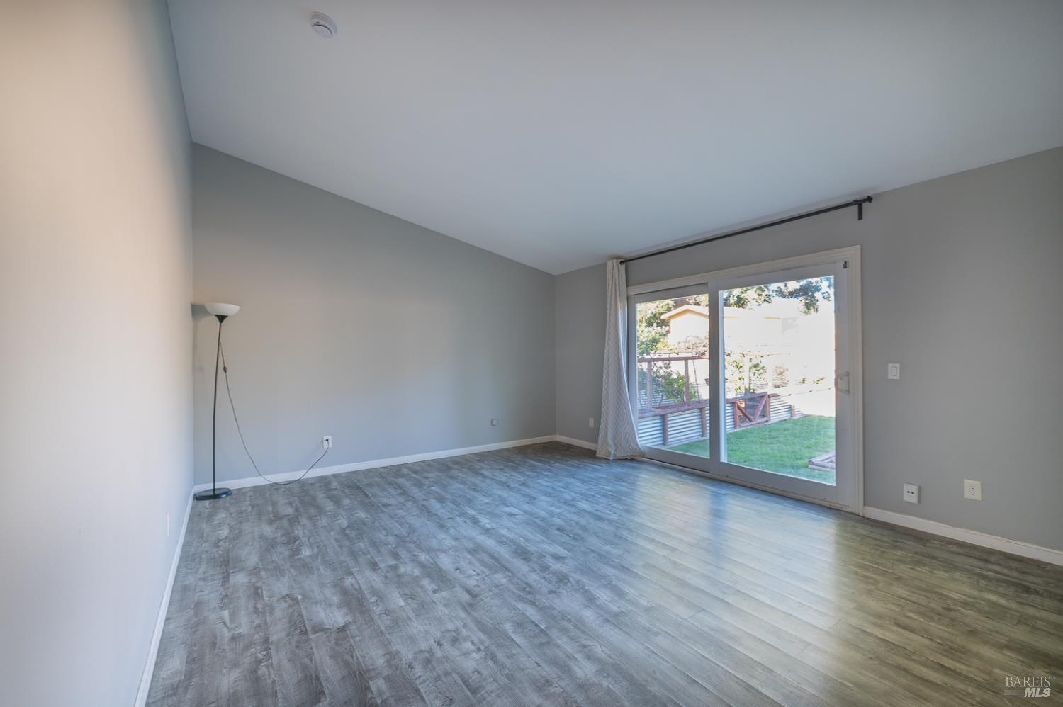 978 Eleanor Avenue Rohnert Park, CA 94928 - Photo 19 of 36 an empty room with wooden floor and windows