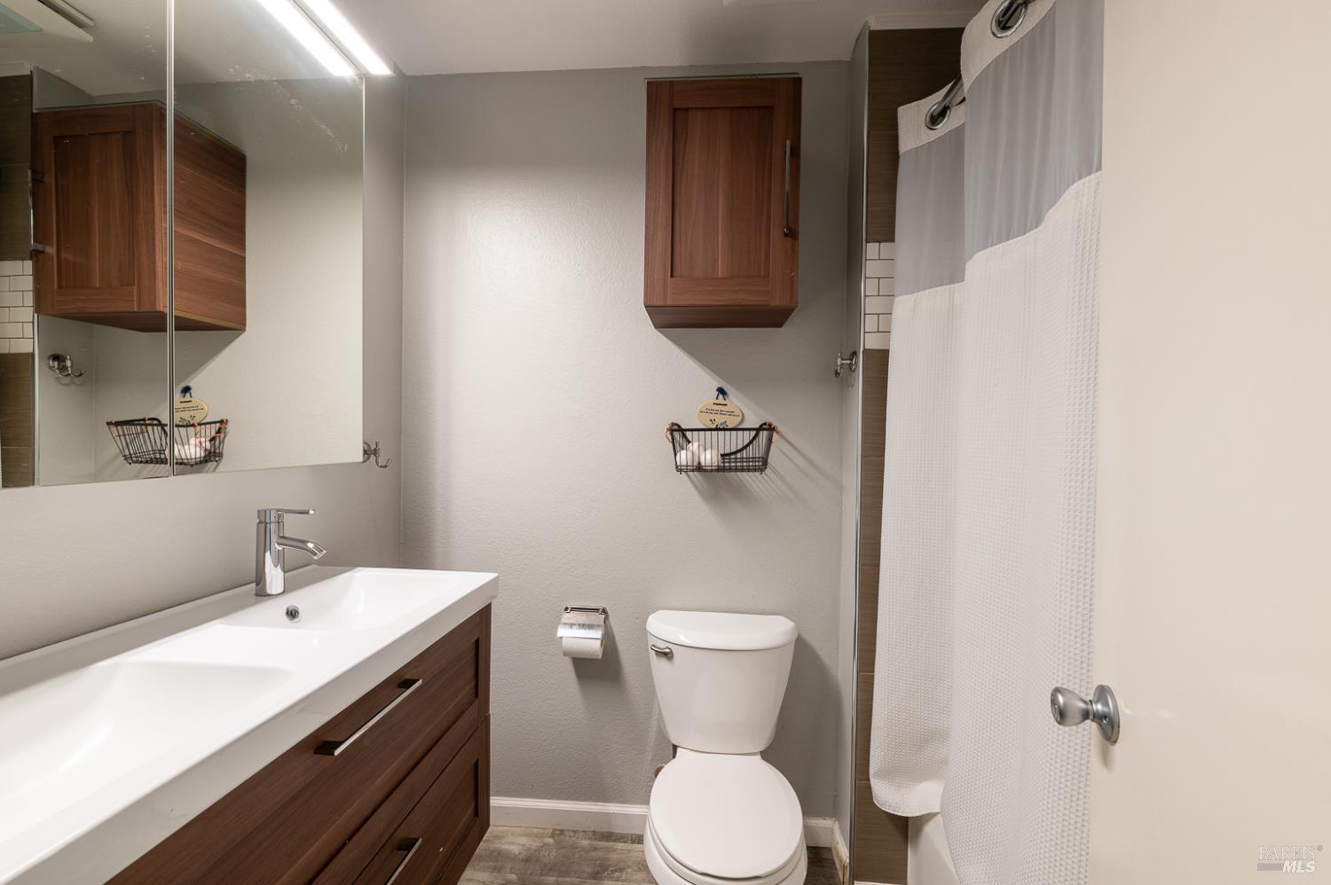 978 Eleanor Avenue Rohnert Park, CA 94928 - Photo 21 of 36 a bathroom with a sink a toilet and mirror