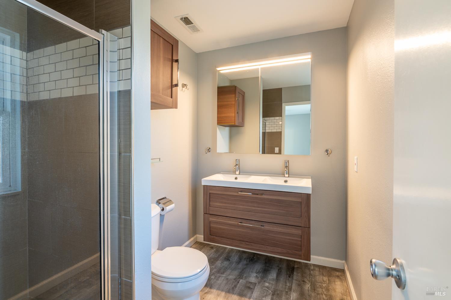 978 Eleanor Avenue Rohnert Park, CA 94928 - Photo 27 of 36 a bathroom with a toilet a sink and mirror