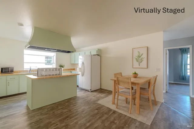 a kitchen with a table and chairs in it