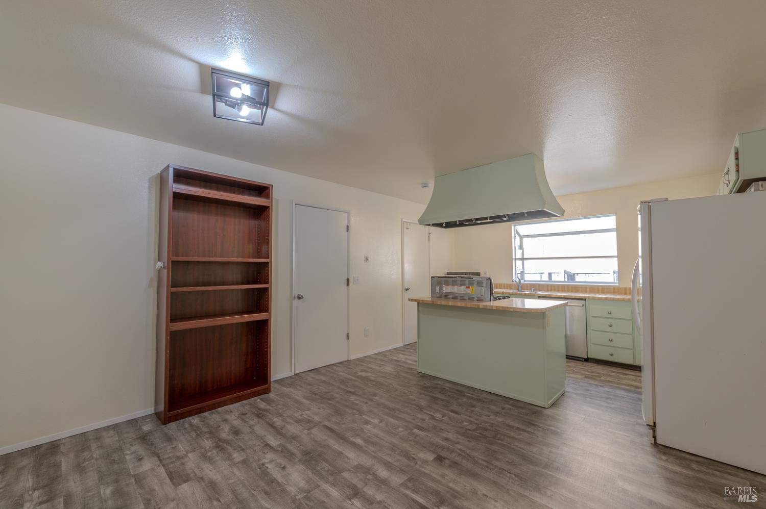 978 Eleanor Avenue Rohnert Park, CA 94928 - Photo 7 of 36 a kitchen with a refrigerator and a stove top oven