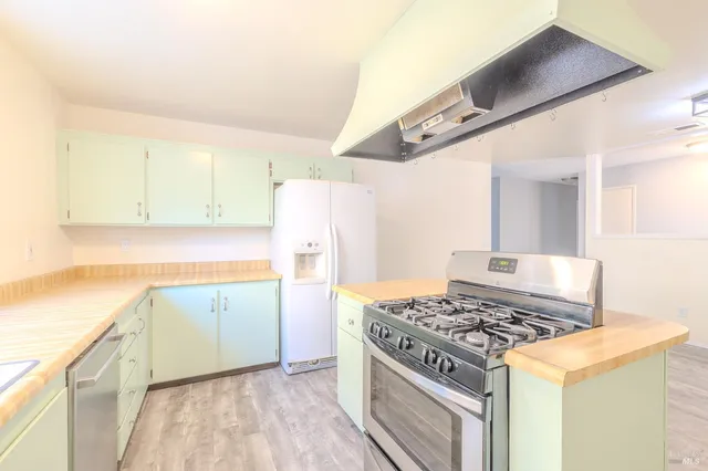 a kitchen with a stove and a refrigerator