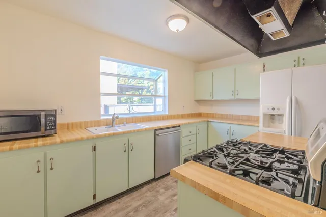 a kitchen with a stove a sink and a refrigerator