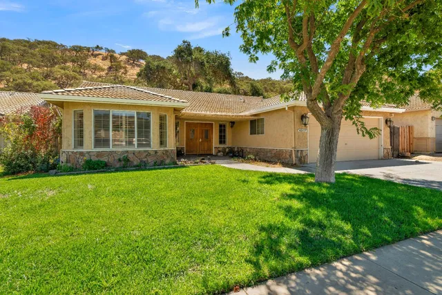 a front view of house with yard and green space