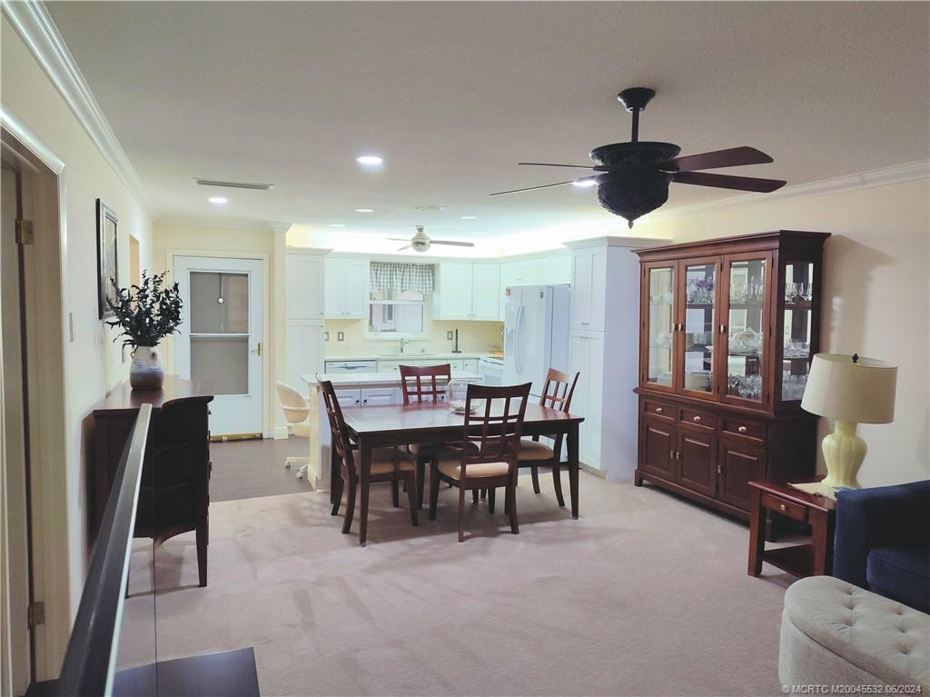 Undisclosed Address Stuart, FL 34997 - Photo 14 of 64 a view of a dining room with furniture a kitchen and chandelier