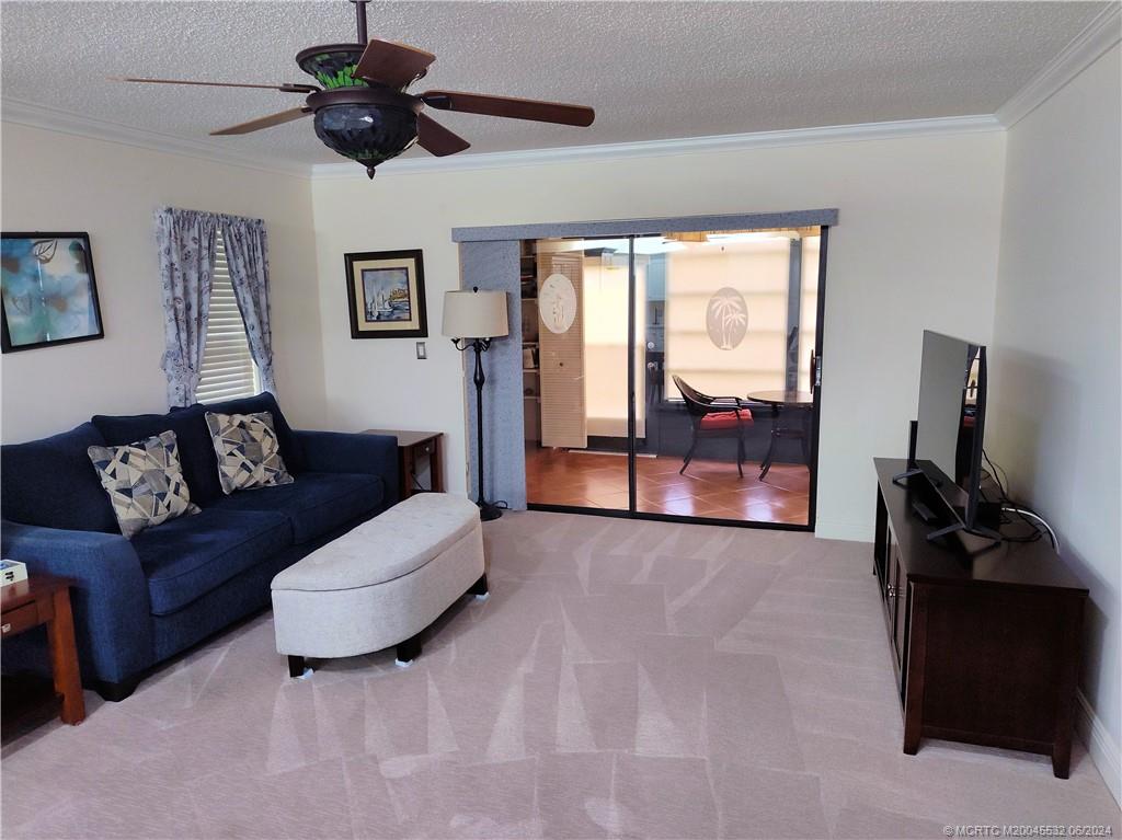 Undisclosed Address Stuart, FL 34997 - Photo 17 of 64 a living room with furniture and a flat screen tv