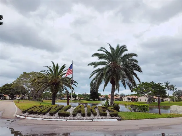 a kitchen with a dining table chairs and refrigerator