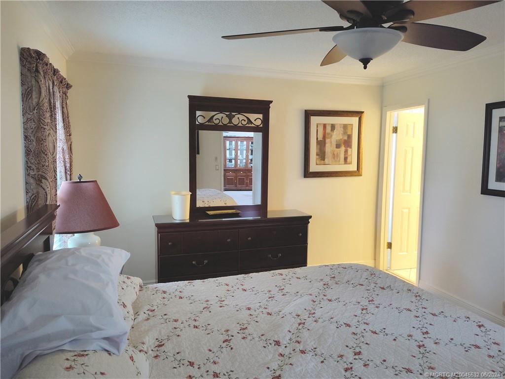 Undisclosed Address Stuart, FL 34997 - Photo 21 of 64 a bedroom with a bed and wooden floor