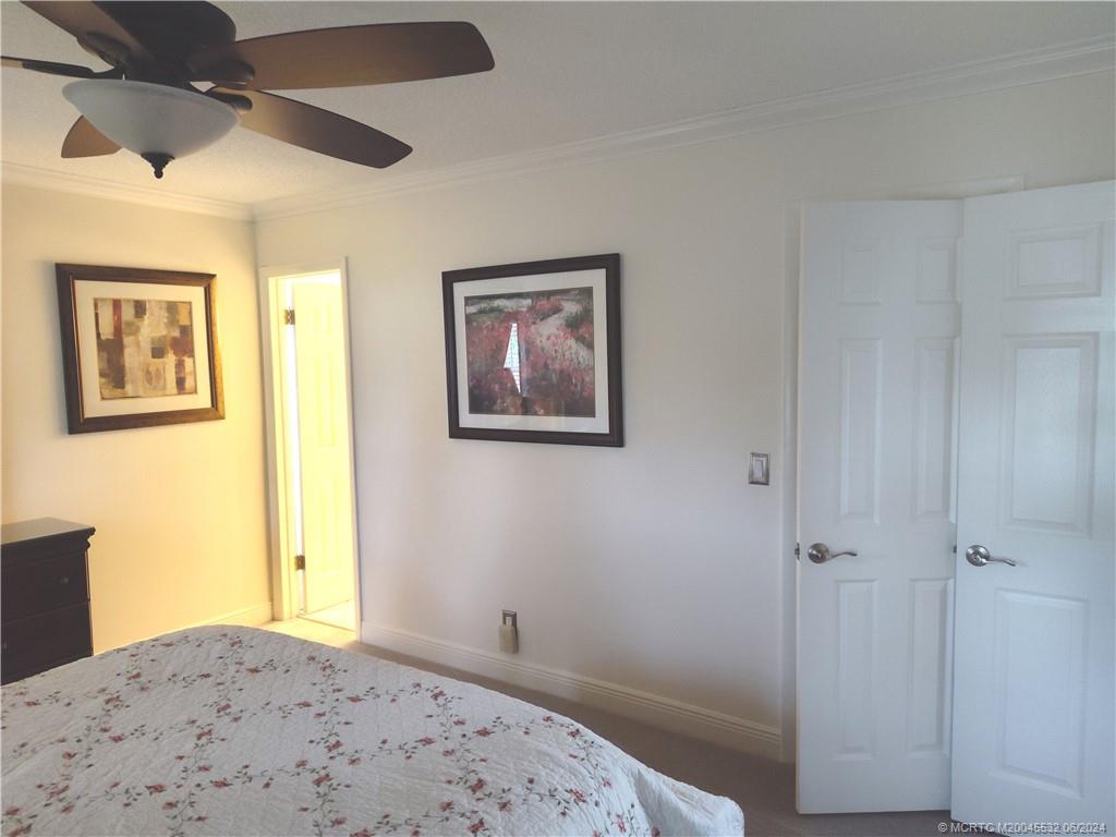 Undisclosed Address Stuart, FL 34997 - Photo 22 of 64 a bedroom with a bed and a window