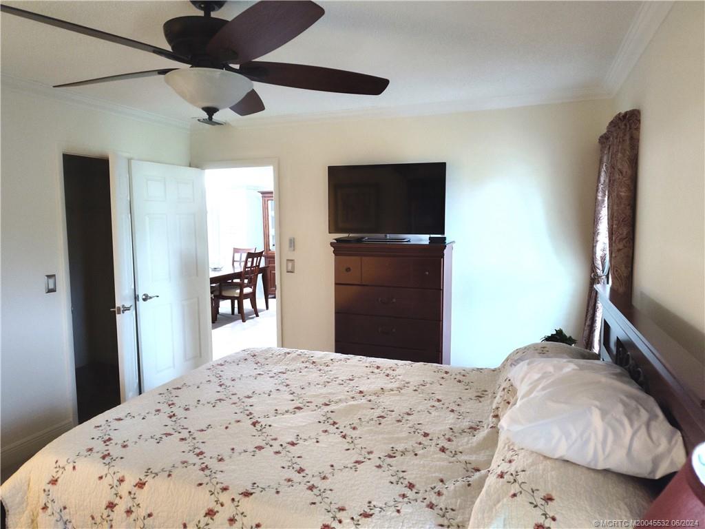 Undisclosed Address Stuart, FL 34997 - Photo 25 of 64 a bedroom with a bed and a flat screen tv