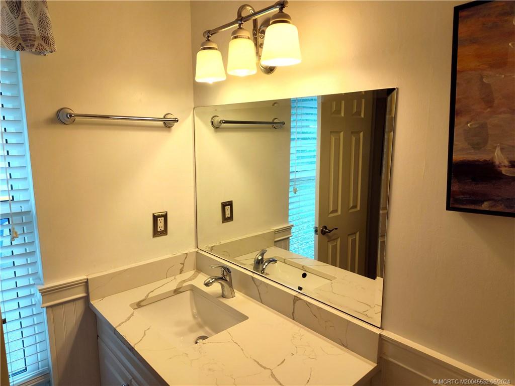 Undisclosed Address Stuart, FL 34997 - Photo 27 of 64 a bathroom with a granite countertop sink and a mirror