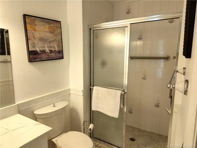 a bedroom with a bed and a chandelier fan