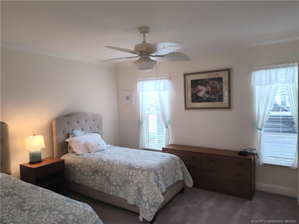 Undisclosed Address Stuart, FL 34997 - Photo 31 of 64 a bedroom with a bed and a chandelier