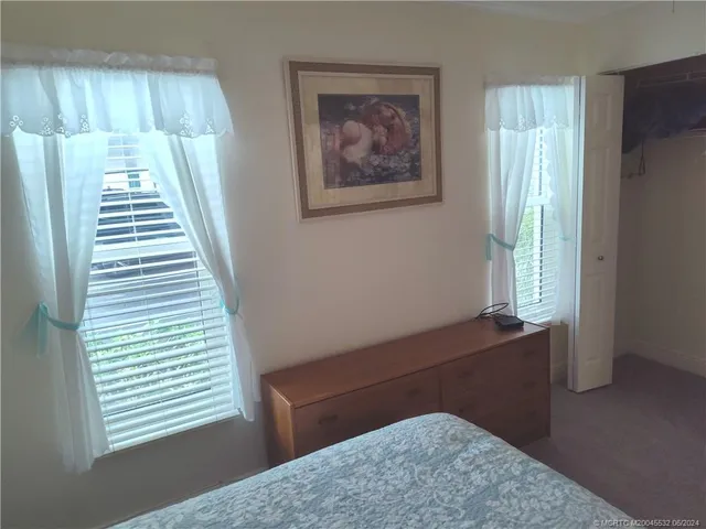 a view of room with window and wooden floor