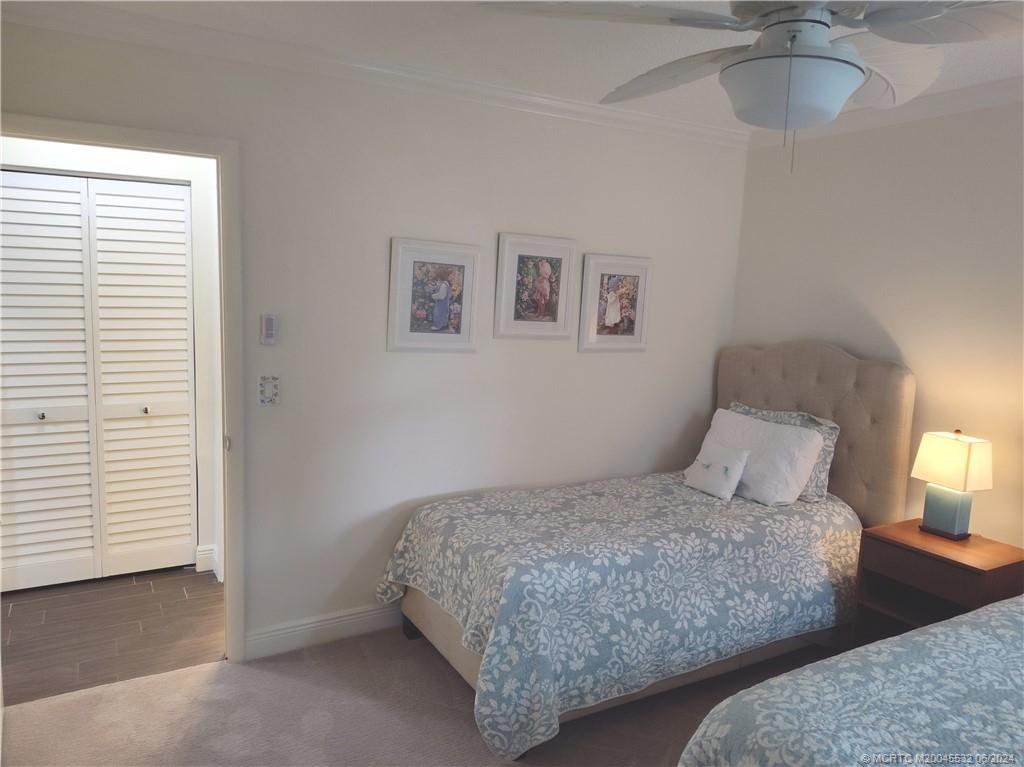 Undisclosed Address Stuart, FL 34997 - Photo 35 of 64 a bedroom with a bed and a painting on the wall