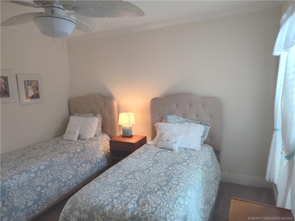 Undisclosed Address Stuart, FL 34997 - Photo 36 of 64 a bedroom with a large bed and a chandelier