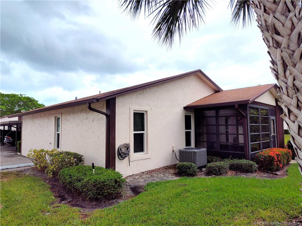 Undisclosed Address Stuart, FL 34997 - Photo 49 of 64 a front view of a house with a garden and plants
