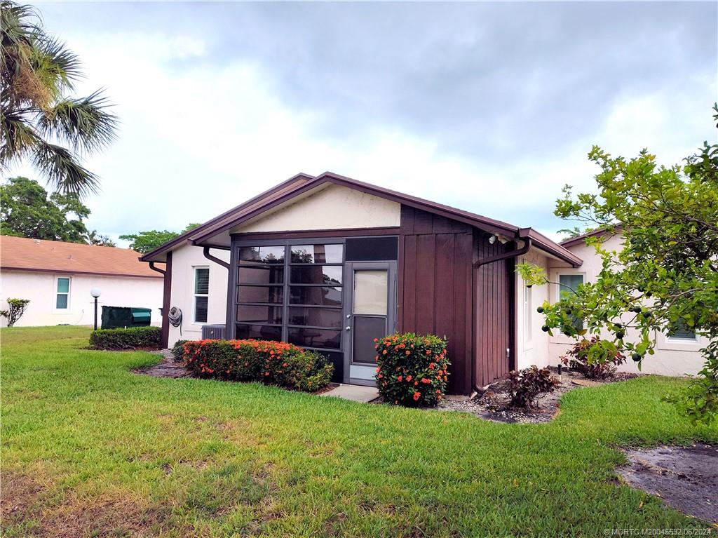 Undisclosed Address Stuart, FL 34997 - Photo 50 of 64 a front view of a house with garden