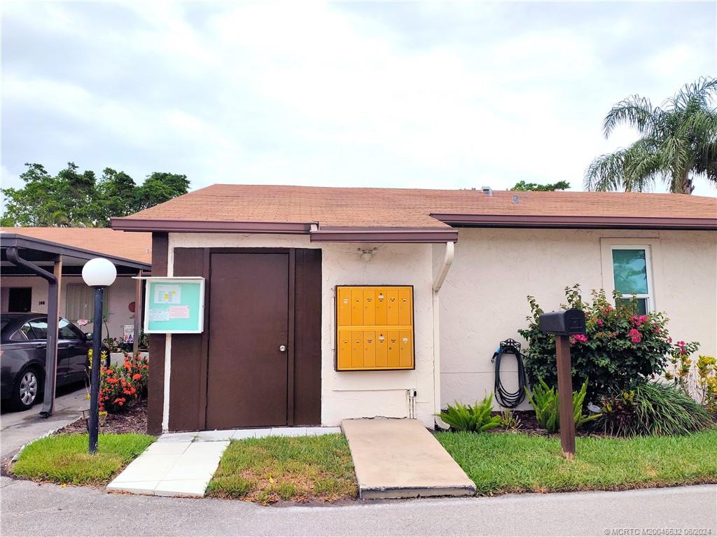 Undisclosed Address Stuart, FL 34997 - Photo 53 of 64 a front view of a house with garden
