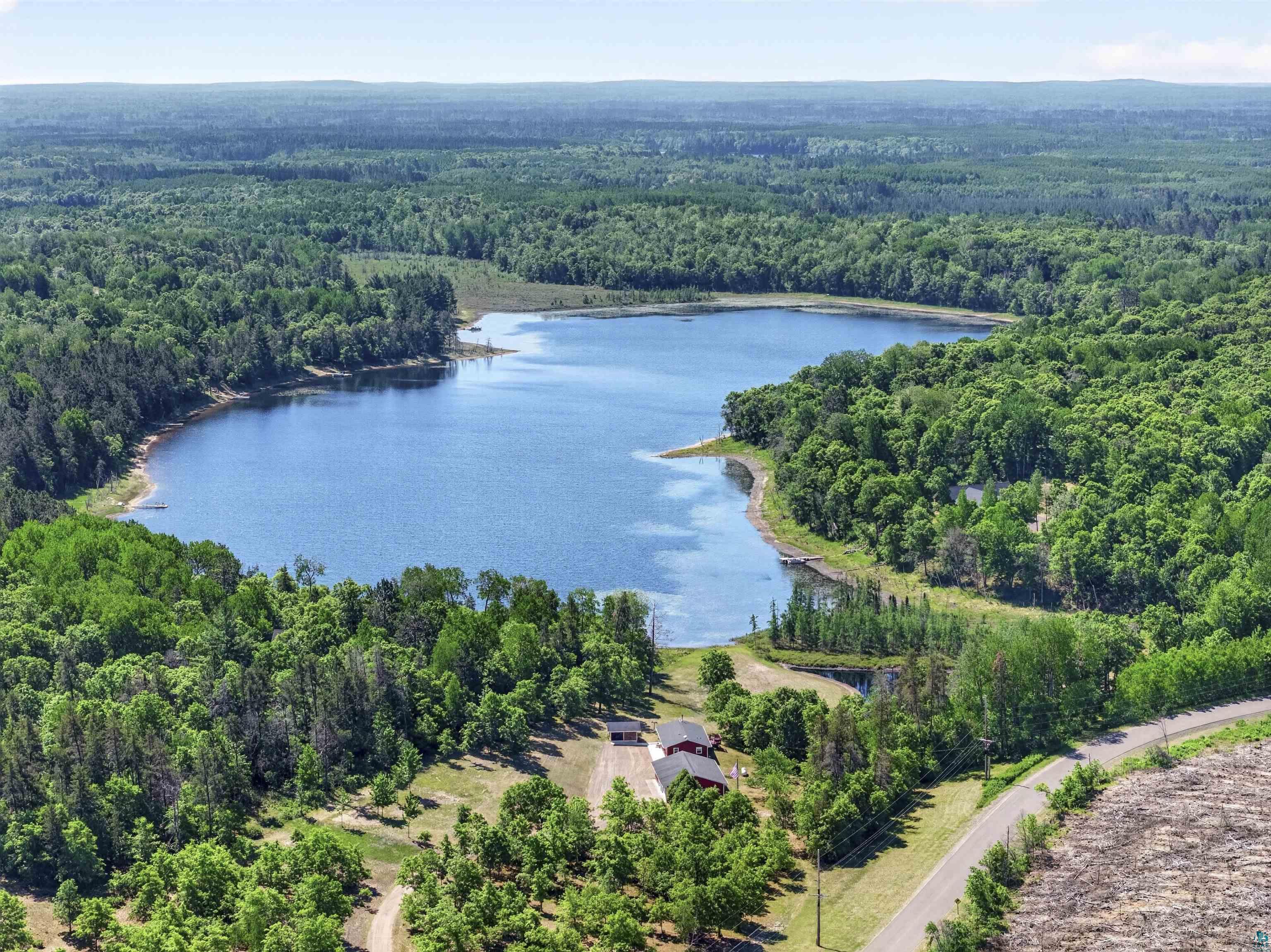 11702 East Mail Road Gordon, WI 54838 - Photo 2 of 60 Expansive natural landscape featuring a large body of water surrounded by dense green forest