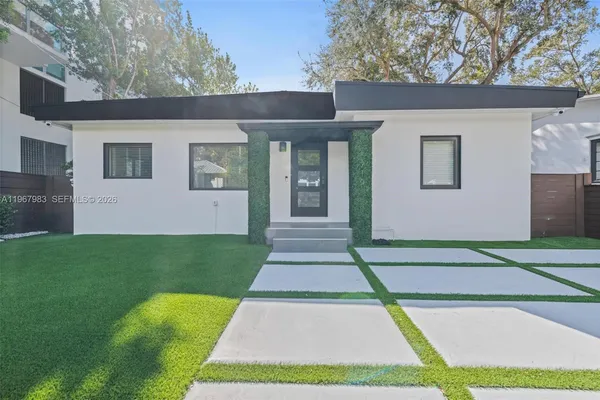 a front view of a house with a yard
