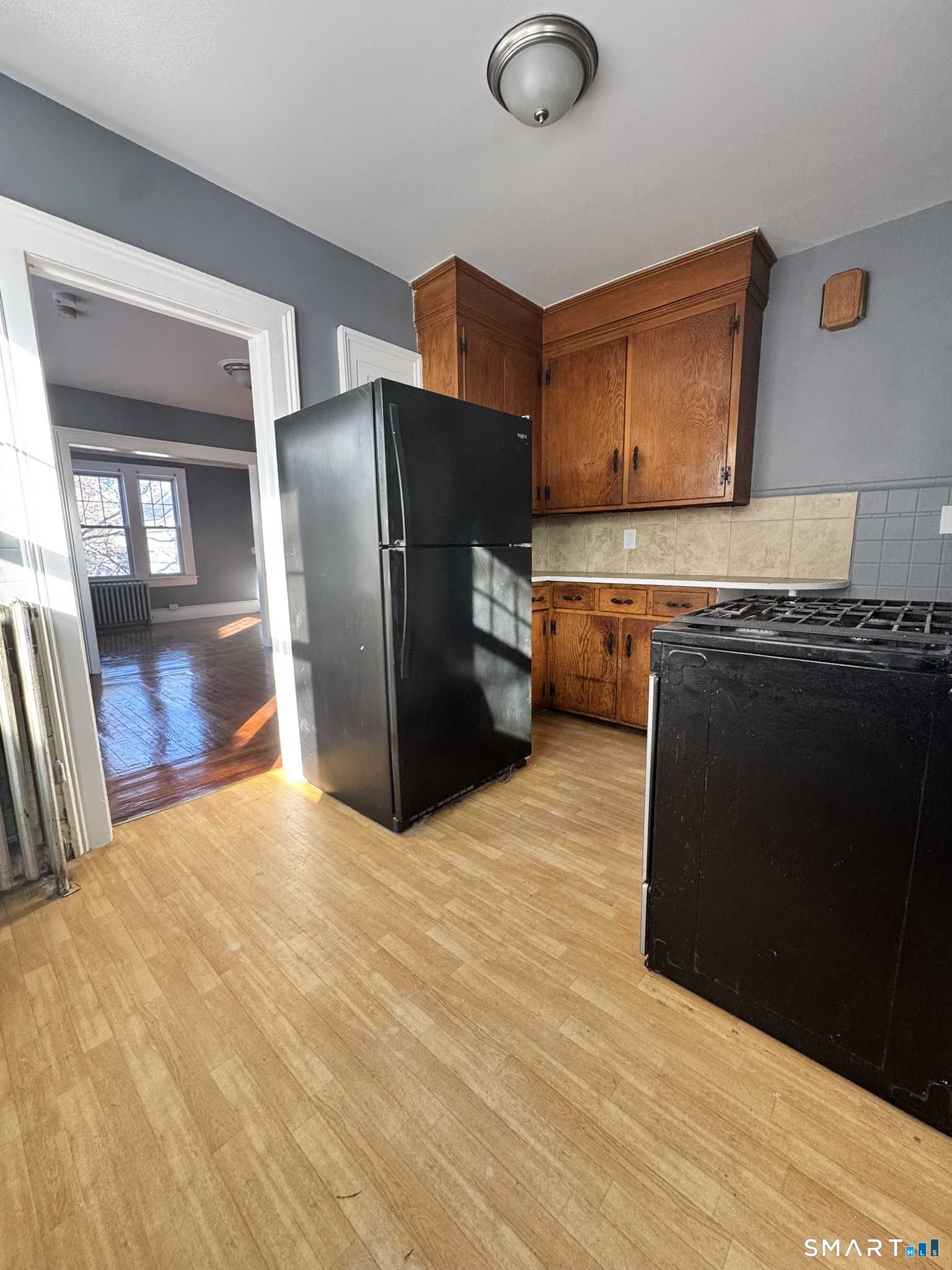 26 Lander Street New Haven, CT 06511 - Photo 17 of 26 a kitchen with stainless steel appliances granite countertop a refrigerator a stove and a sink with wooden floor