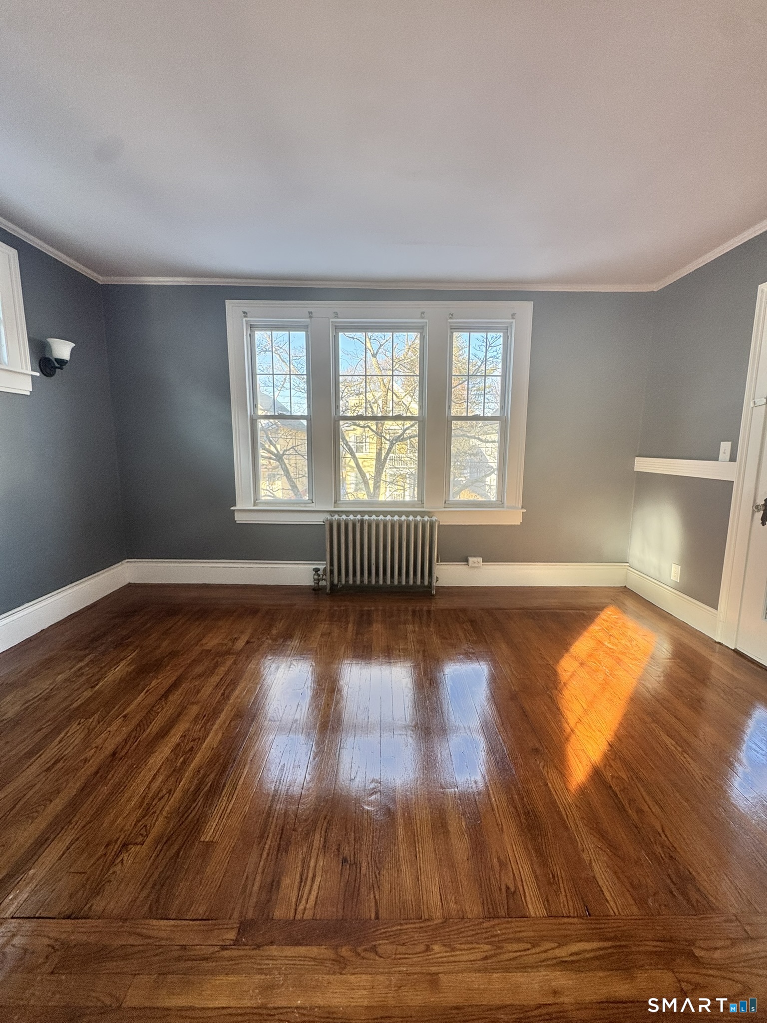 26 Lander Street New Haven, CT 06511 - Photo 19 of 26 a view of empty room with wooden floor and fan