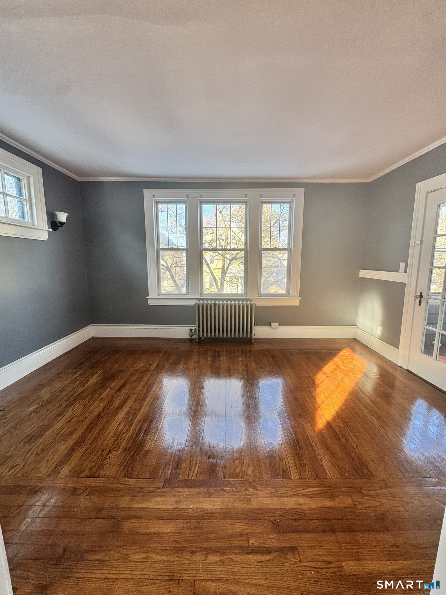 26 Lander Street New Haven, CT 06511 - Photo 20 of 26 a view of empty room with wooden floor and fan
