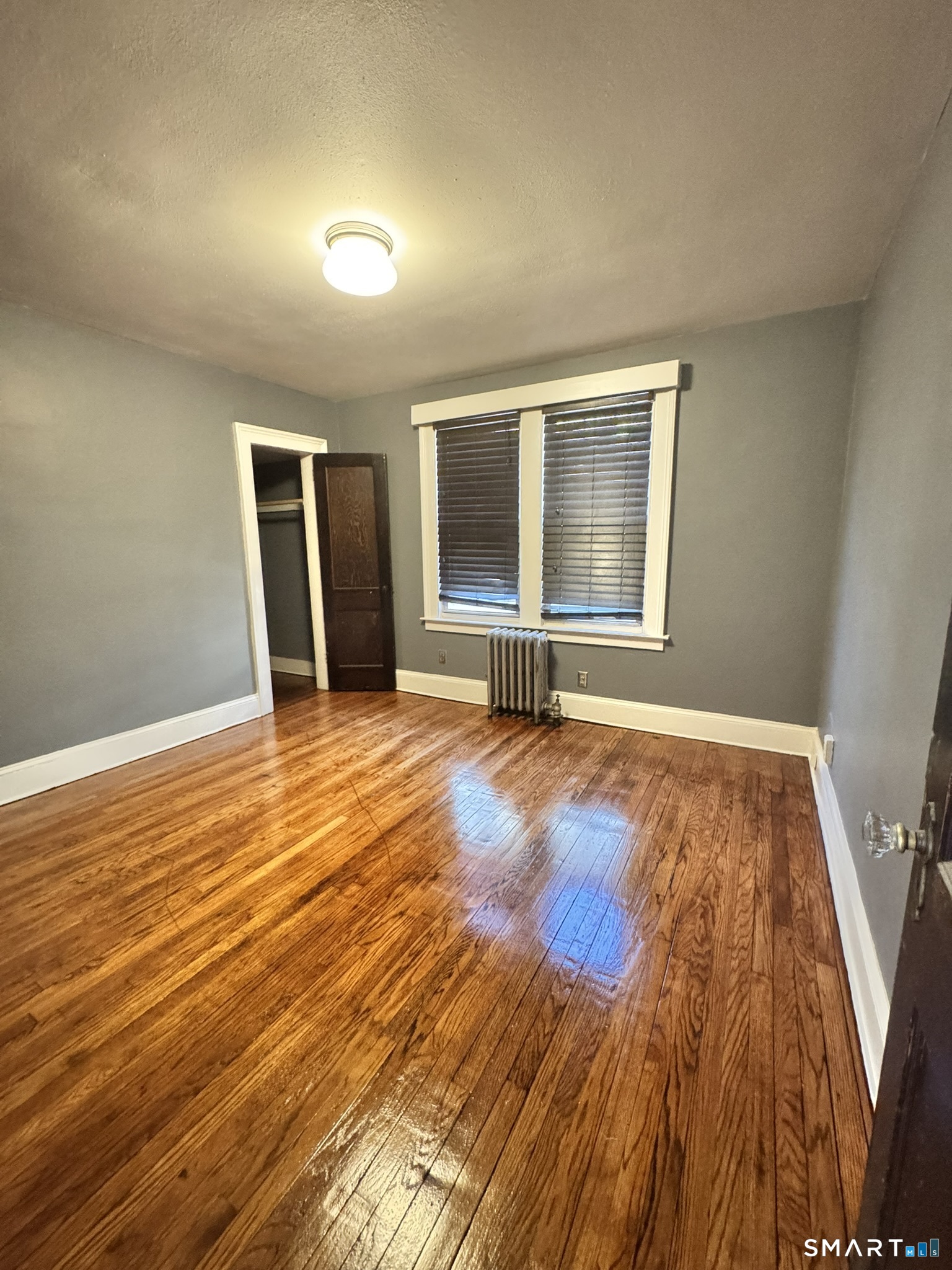 26 Lander Street New Haven, CT 06511 - Photo 6 of 26 a view of an empty room with wooden floor and a window
