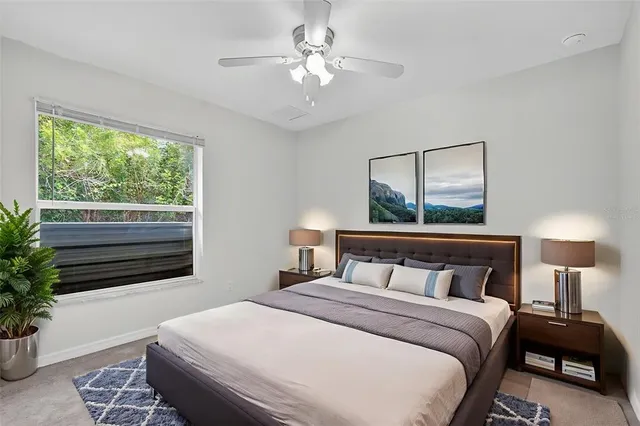 a bedroom with a large bed and a window