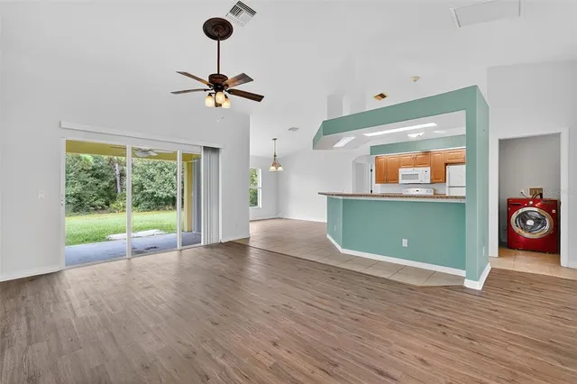 a view of a room with a window and wooden floor