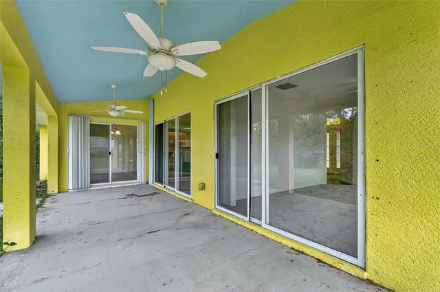 a view of a hallway with a ceiling fan