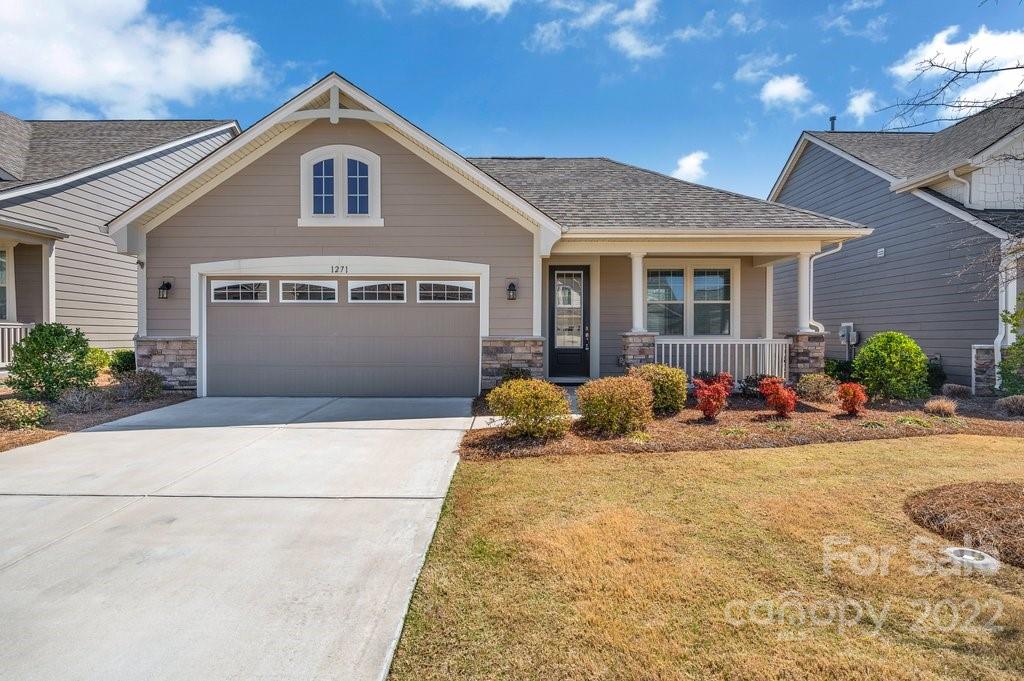 1271 Independence Street Tega Cay, SC 29708 - Photo 1 of 23 a front view of a house with yard and a garage