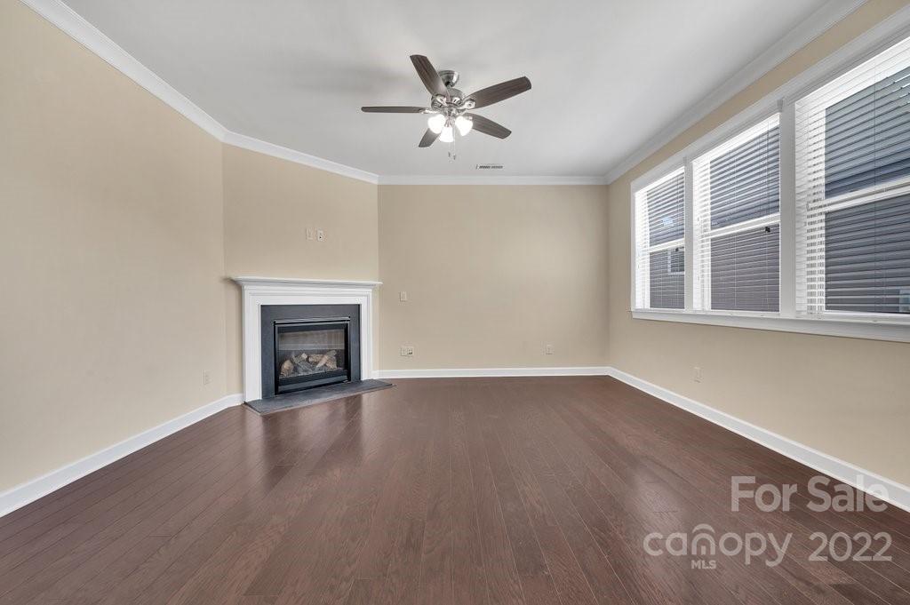 1271 Independence Street Tega Cay, SC 29708 - Photo 11 of 23 a view of an empty room with wooden floor and a window